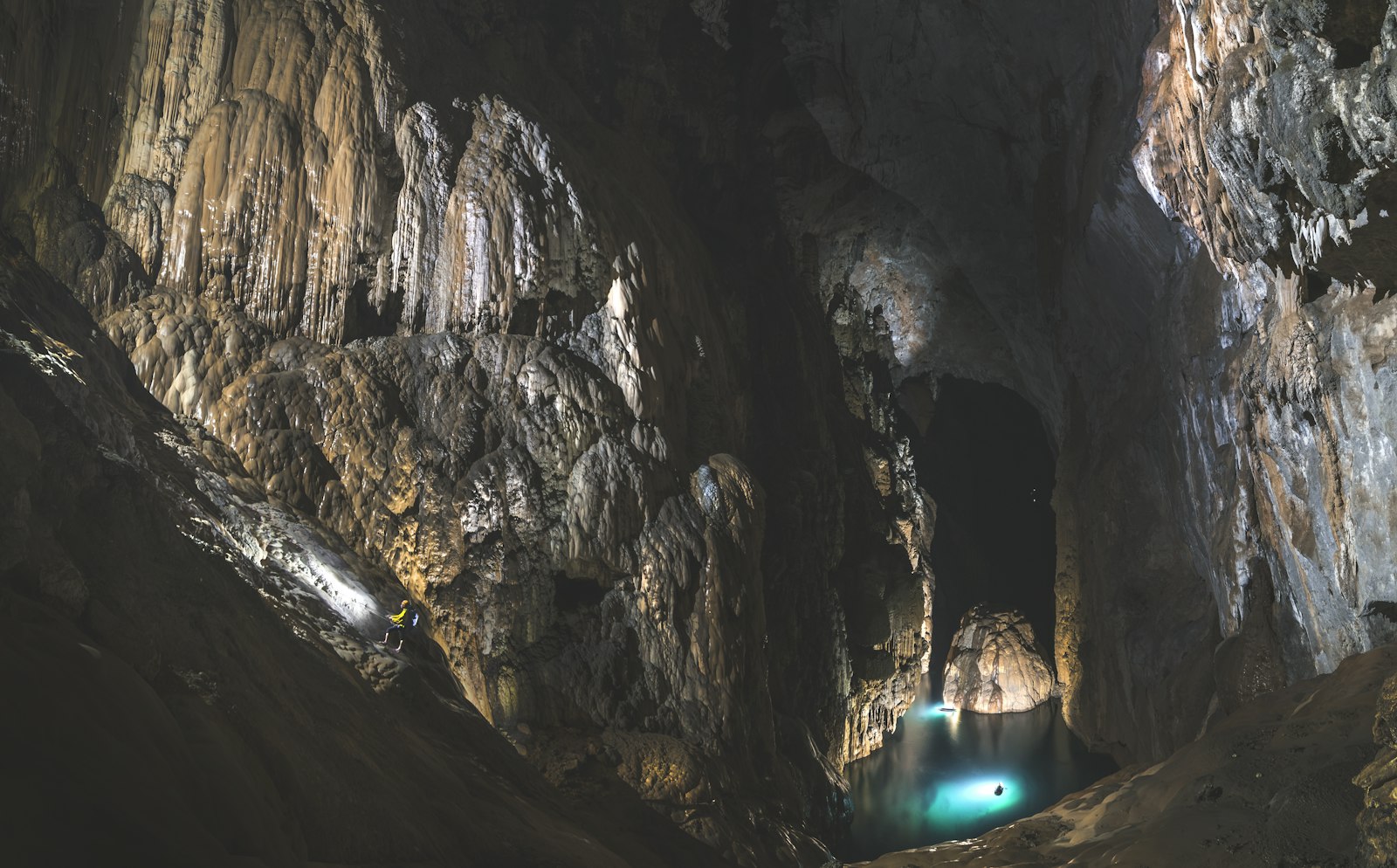 Large cave chamber filled with stalactites