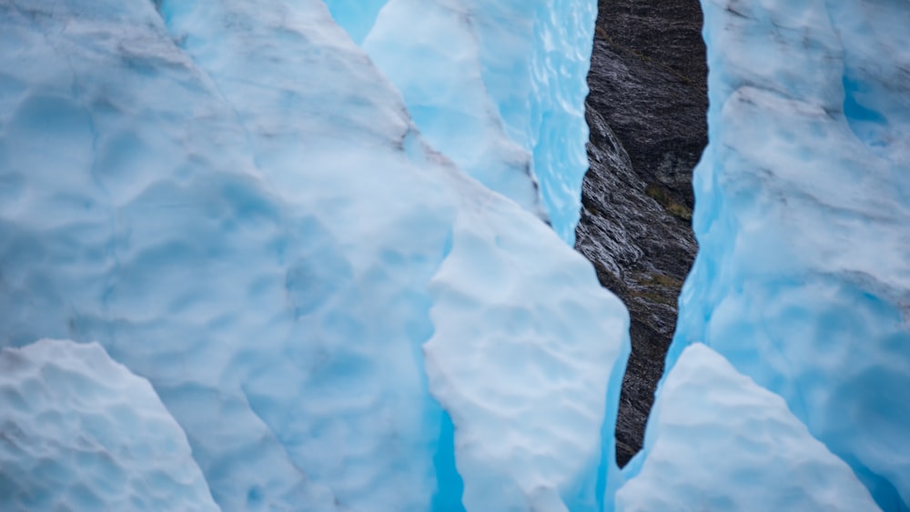 a man standing in the middle of a glacier