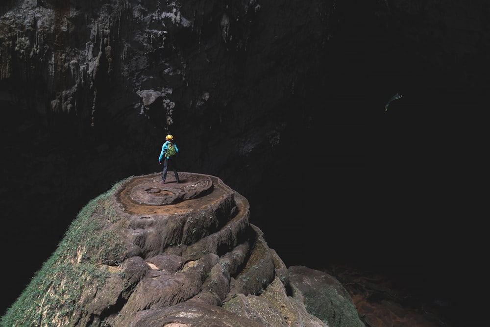 a person standing on top of a rock formation