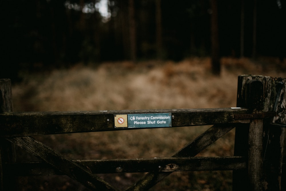 a wooden gate with a sign on it