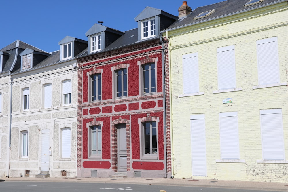 a row of multi - colored buildings on a street corner