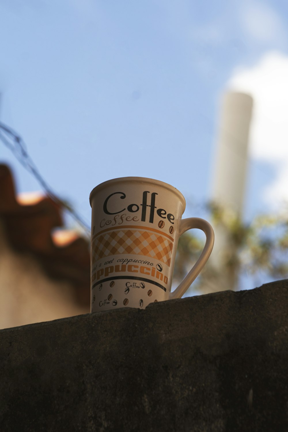 a coffee cup is sitting on a ledge