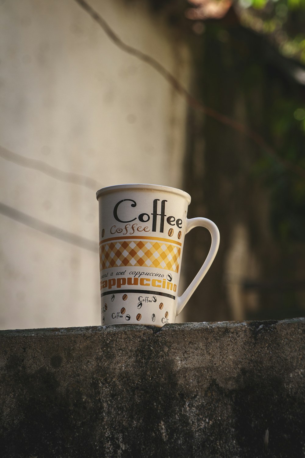 a coffee cup is sitting on a ledge