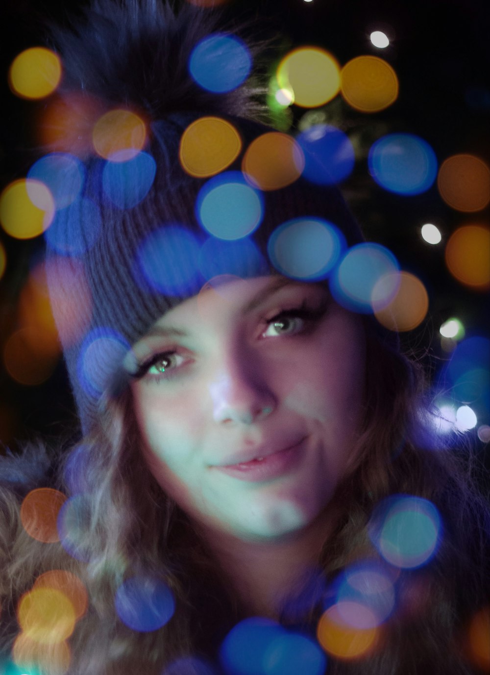 a woman wearing a hat with a blurry background