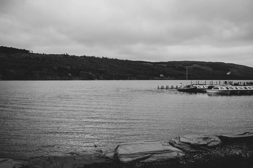 a couple of boats floating on top of a lake