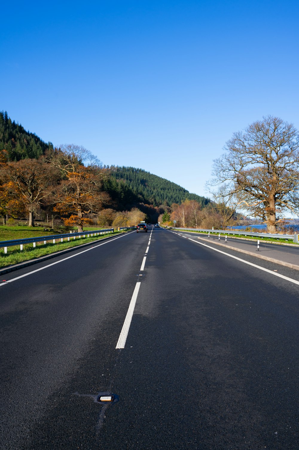 an empty road with a mountain in the background