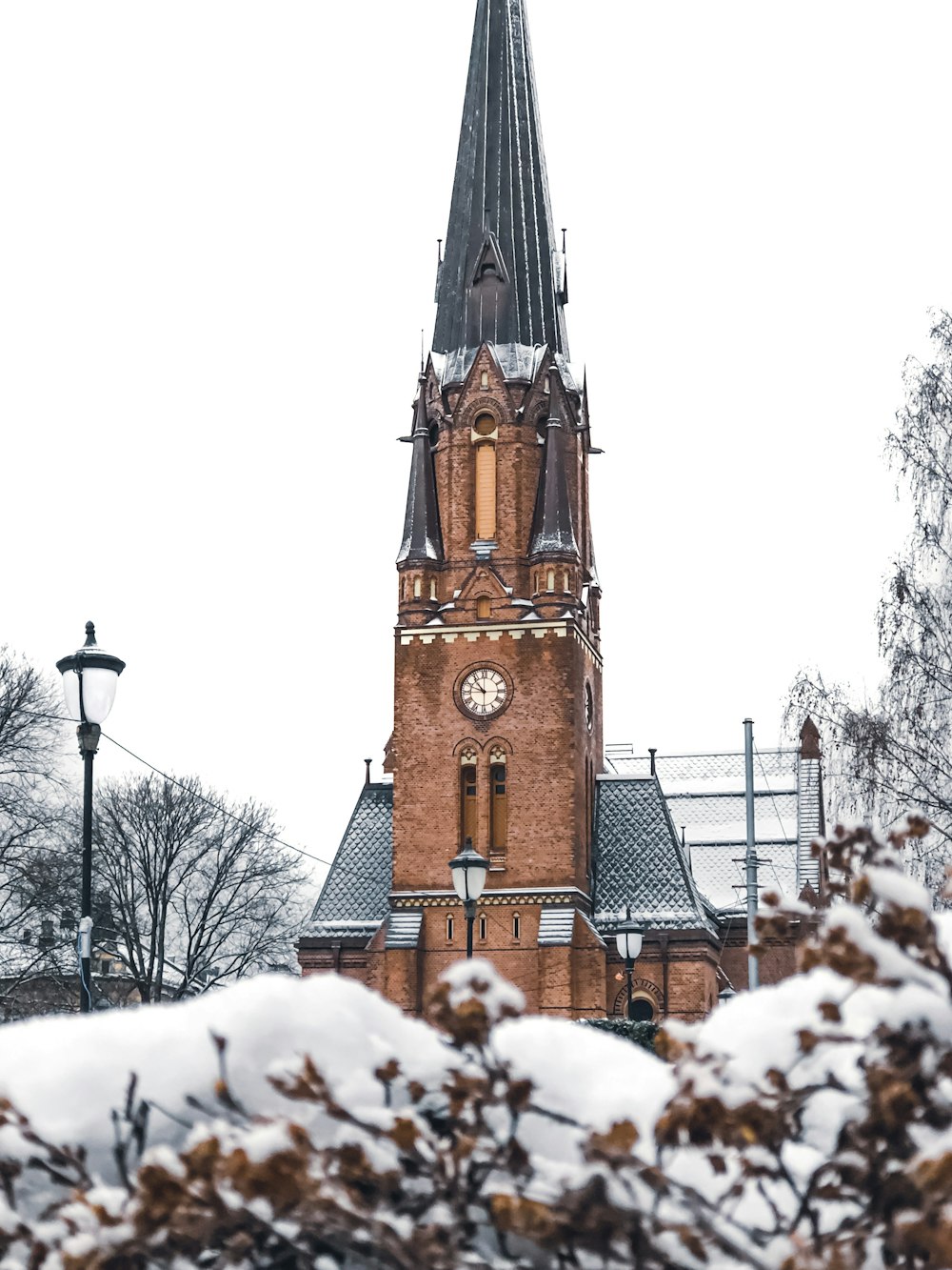 a church tower with a clock in the middle of it