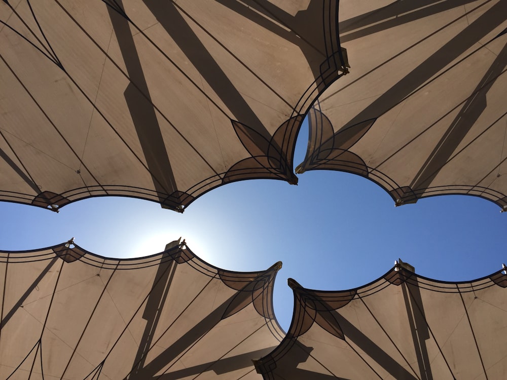 a close up of an umbrella with the sky in the background