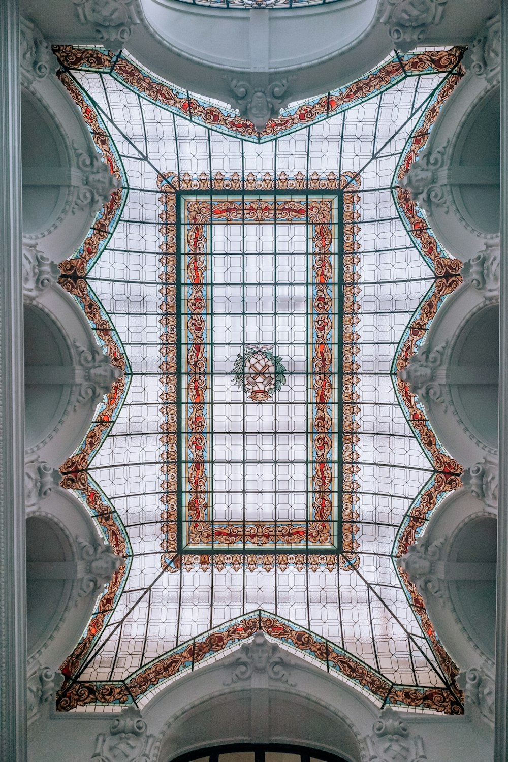 the ceiling of a building with a glass window