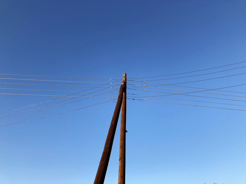 a tall wooden pole sitting next to power lines