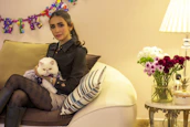 Cat modeling a cute, custom-fit dress with bright colors inside a cozy home.