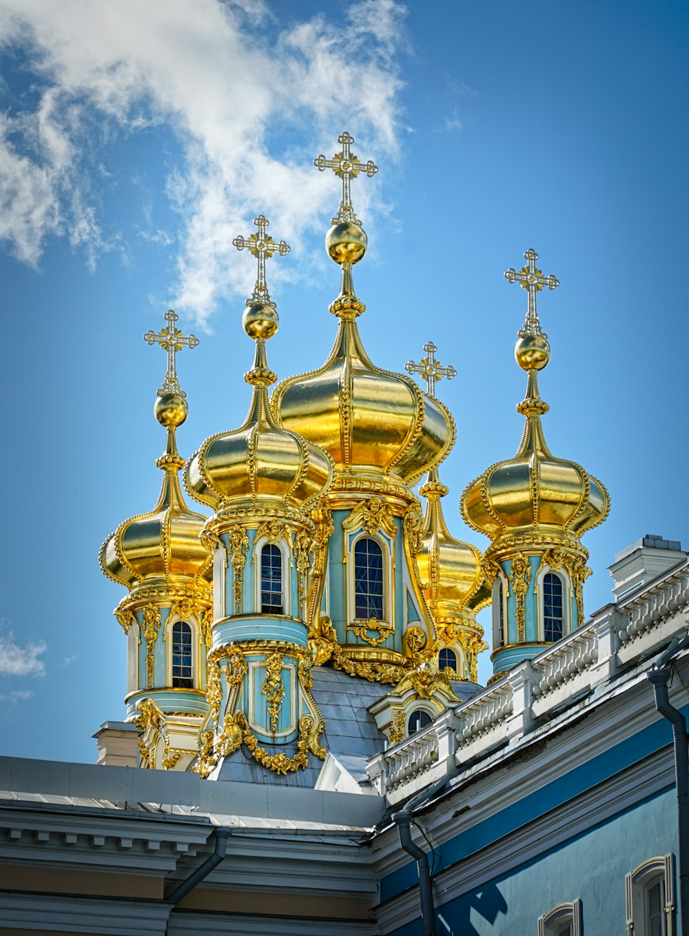 a gold and blue building with a sky background