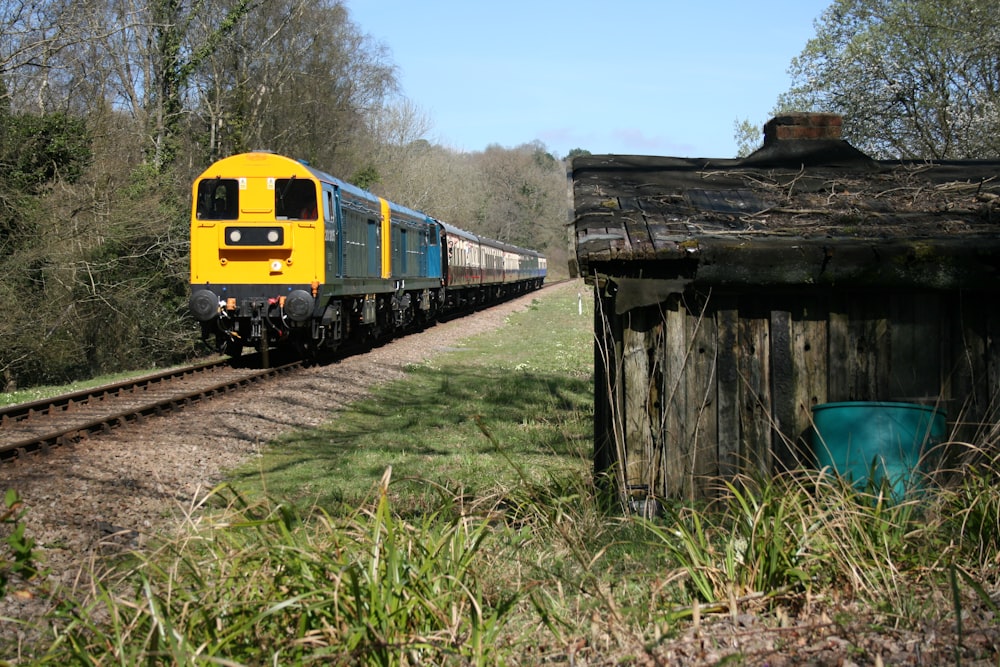 a yellow and blue train traveling down train tracks