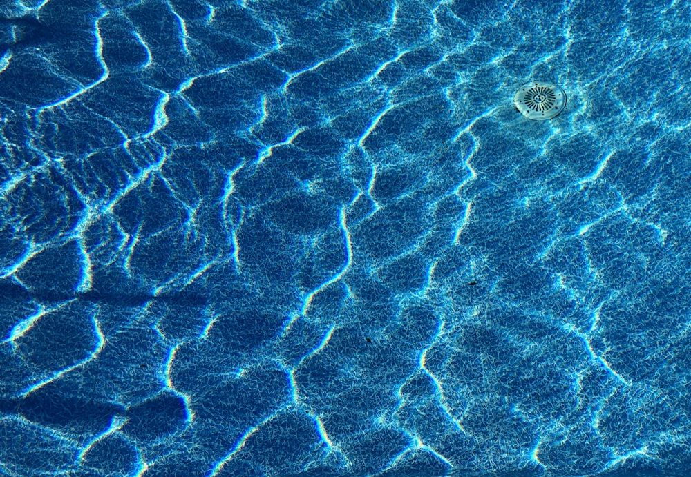 a pool with blue water and ripples of water