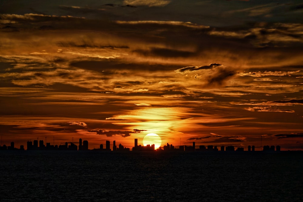 the sun is setting over the city skyline