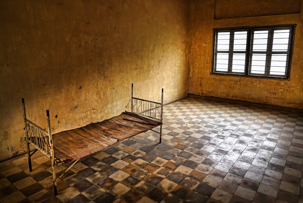 a bed sitting in a room next to a window