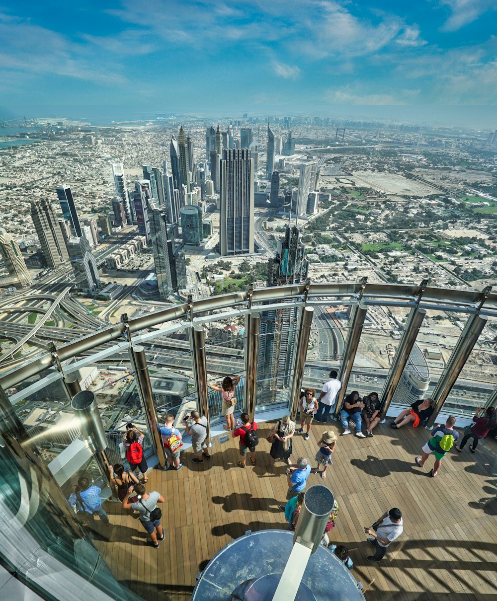 a group of people standing on top of a tall building