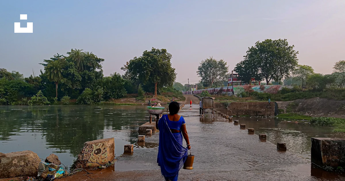 Sari Rivers A woman in a blue sari walking along a river photo – Free Human Image ...