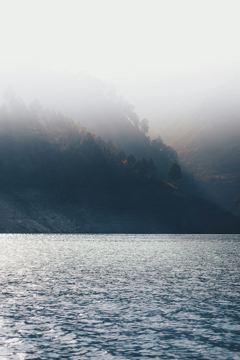 a body of water with a mountain in the background