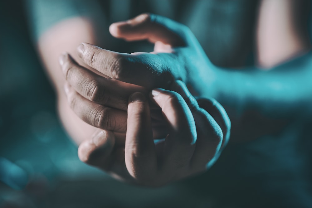 a close up of a person holding their hands together