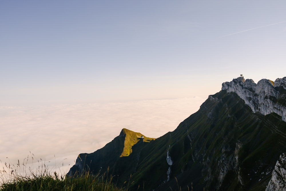 a view of the top of a mountain with a yellow flag in the foreground