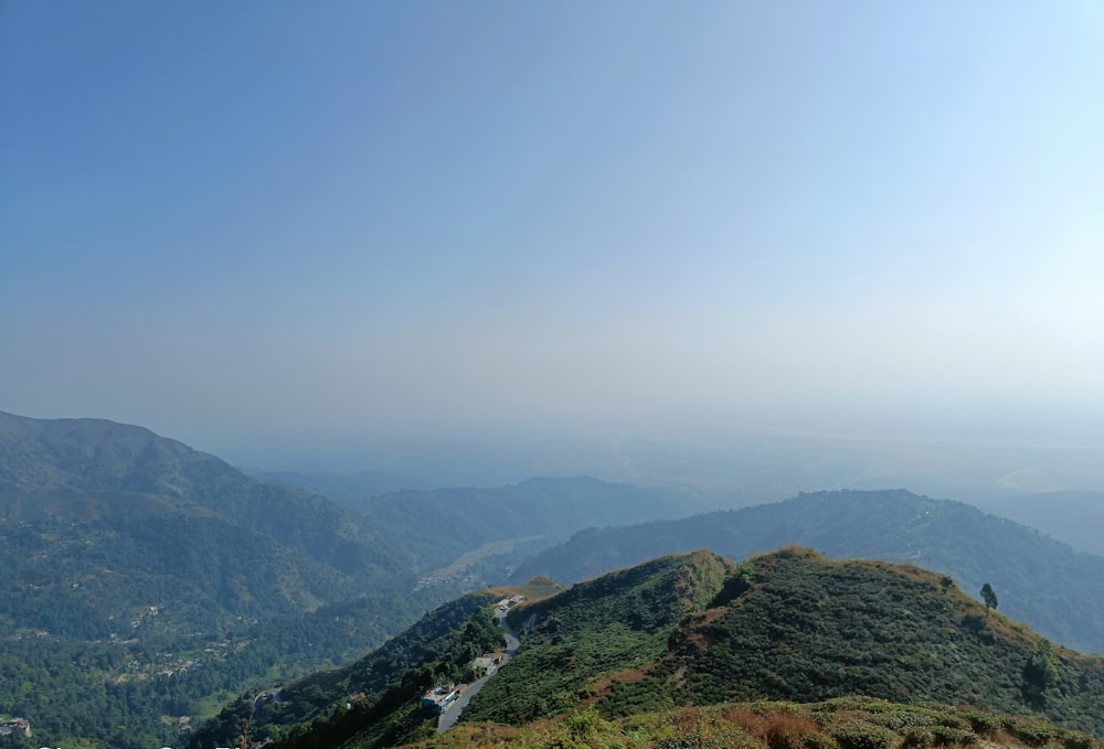 a scenic view of a mountain range with a river running through it