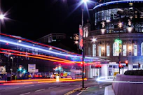 a city street filled with traffic and lights at night