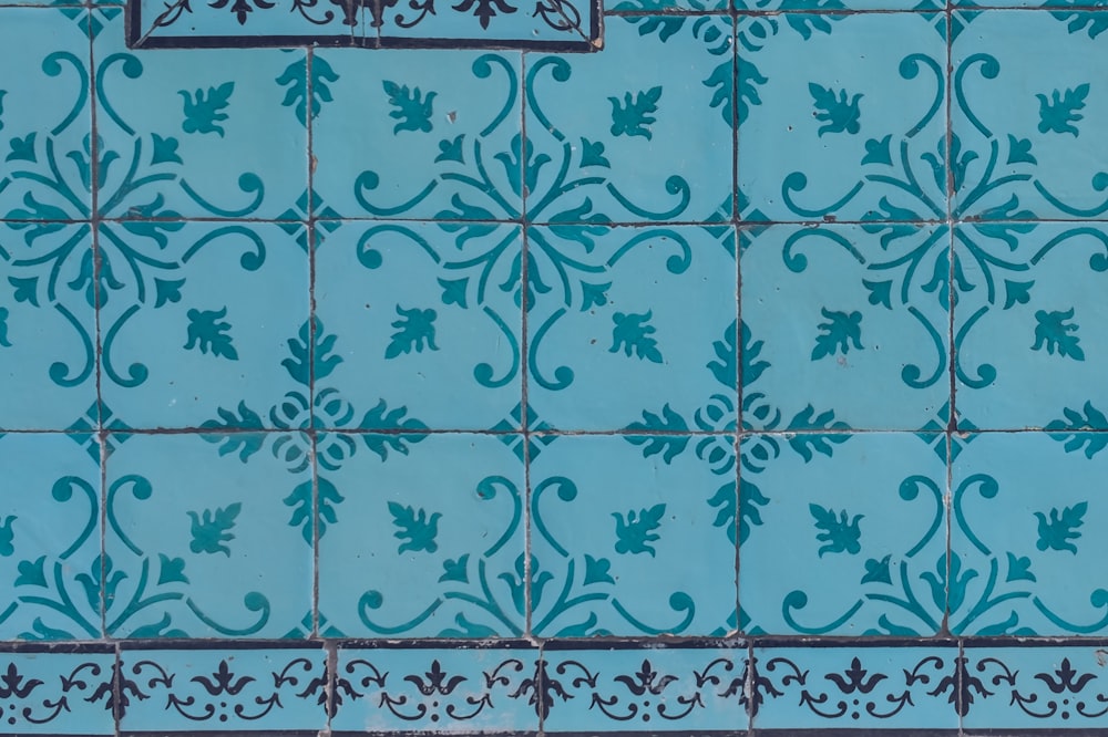 a close up of a blue tiled wall
