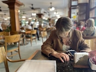 A satisfied user interacting with a mobile app in a cafe.
