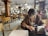 A person using a smartphone while sitting in a cozy cafe.