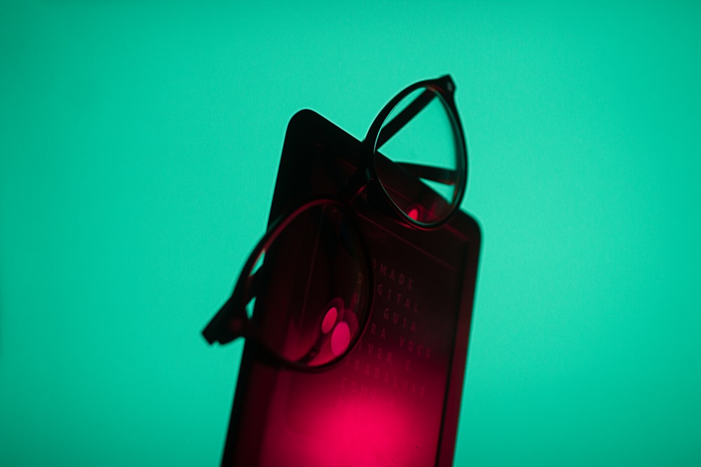 a pair of glasses sitting on top of a red light