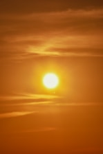 A warm sunrise casting golden light over a calm horizon, symbolizing hope and return.