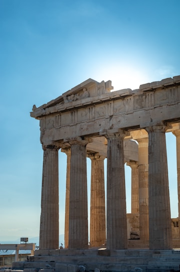 A majestic ancient Greek temple dedicated to Zeus, bathed in golden sunlight.