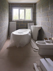 a bath room with a toilet a sink and a bath tub