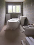 a bath room with a toilet a sink and a bath tub