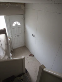 a room with a white door and a white wall