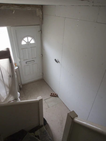 a room with a white door and a white wall