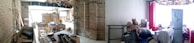 A partially renovated interior space with exposed bricks and beams. The area is cluttered with construction materials, cardboard boxes, and various tools. On the right, there is a small sitting area with a refrigerator, a stuffed animal, and other household items.