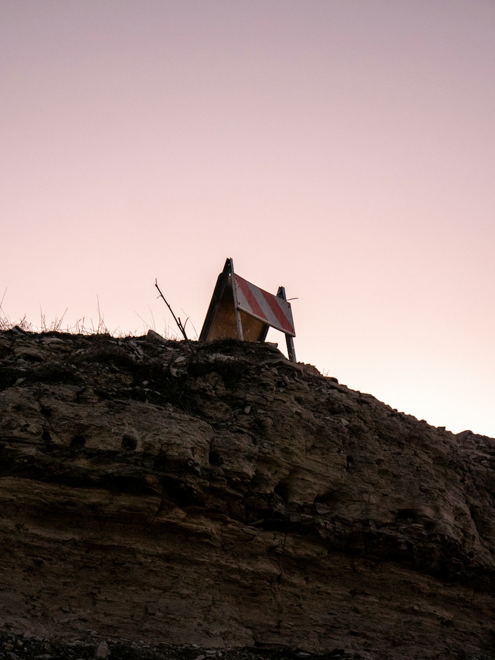 a house sitting on top of a rocky hill