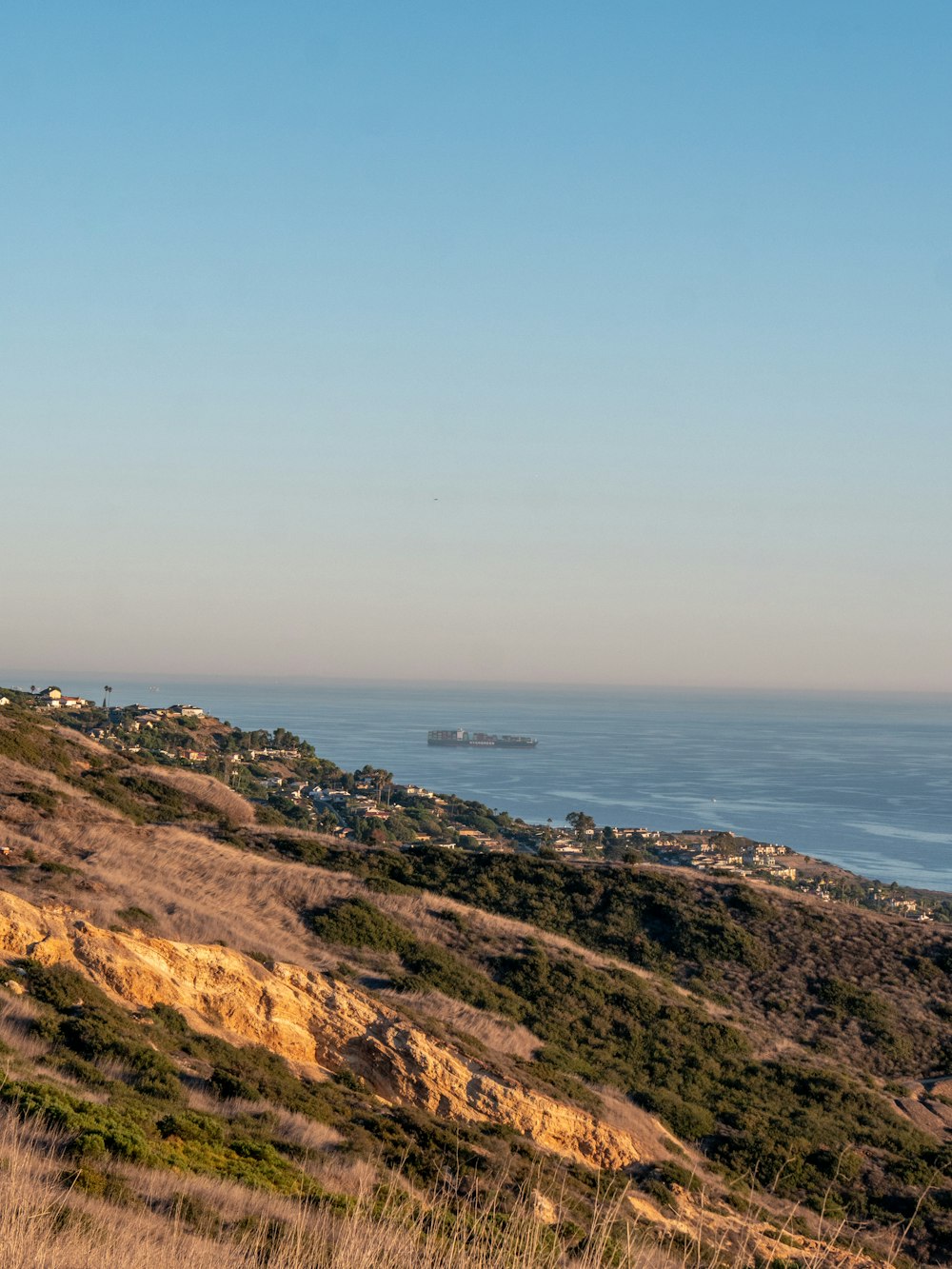 a view of the ocean from the top of a hill