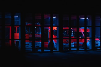 a fire truck is seen through the bars of a jail cell
