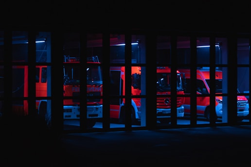 a fire truck is seen through the bars of a jail cell