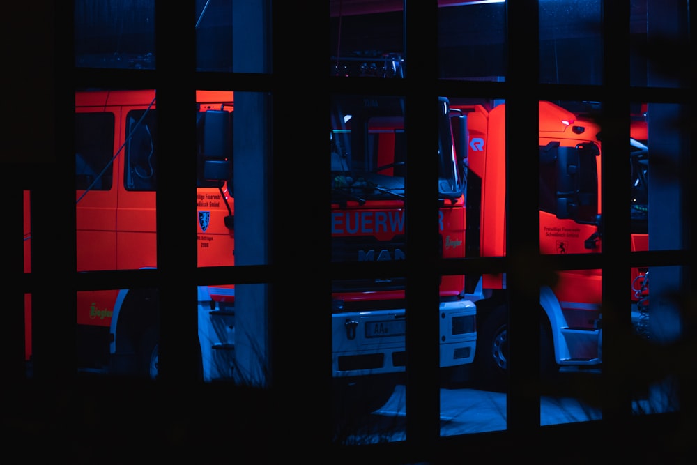 a red truck is seen through a window