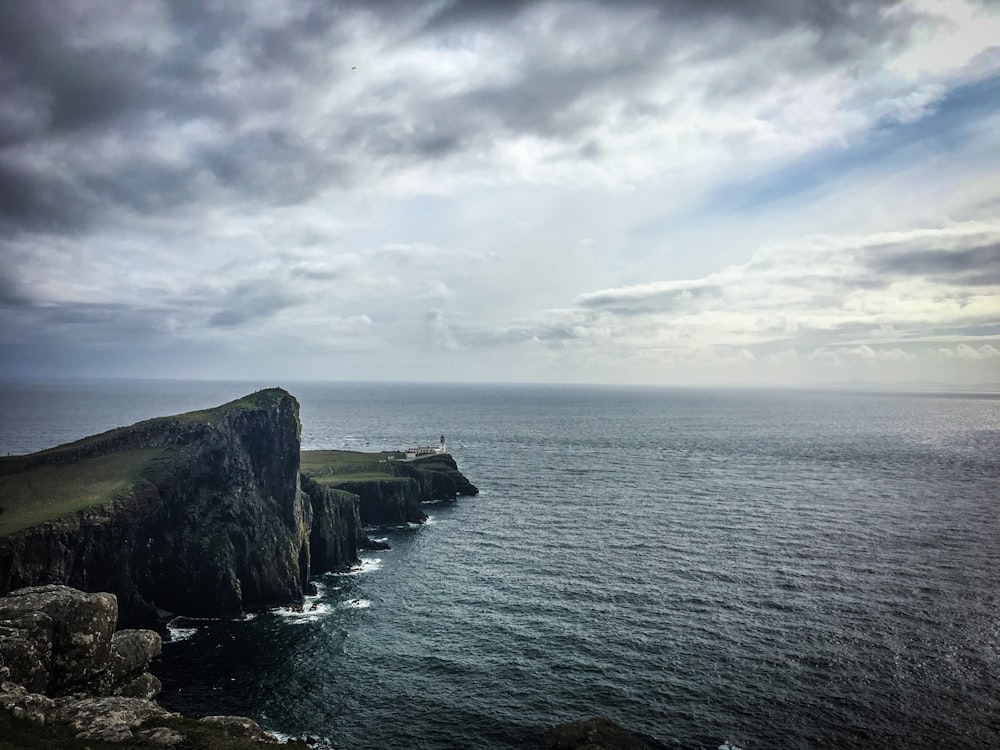 a large body of water sitting next to a cliff