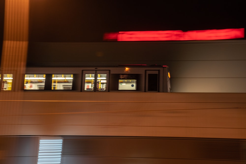 a train traveling past a train station at night