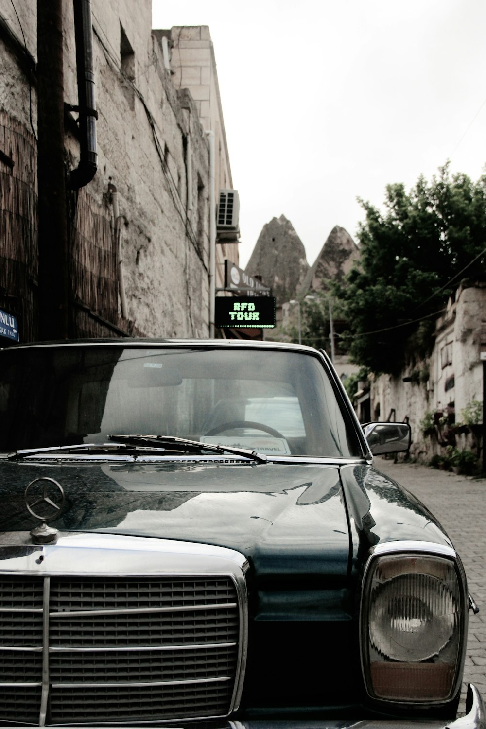 a black car parked on the side of a street