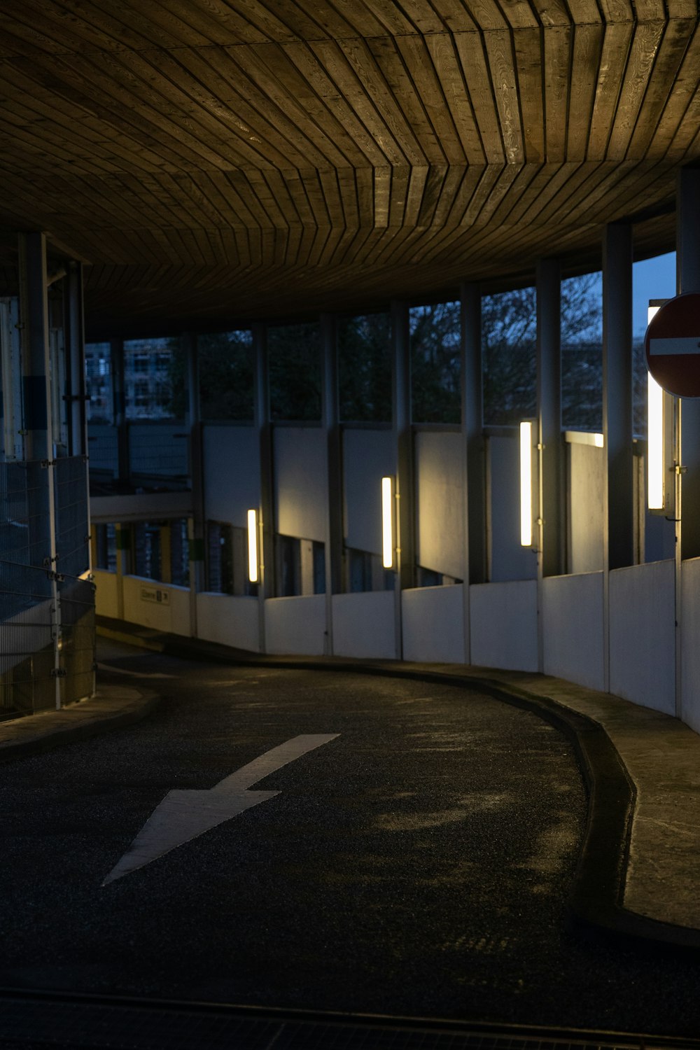 a building with a curved walkway next to it