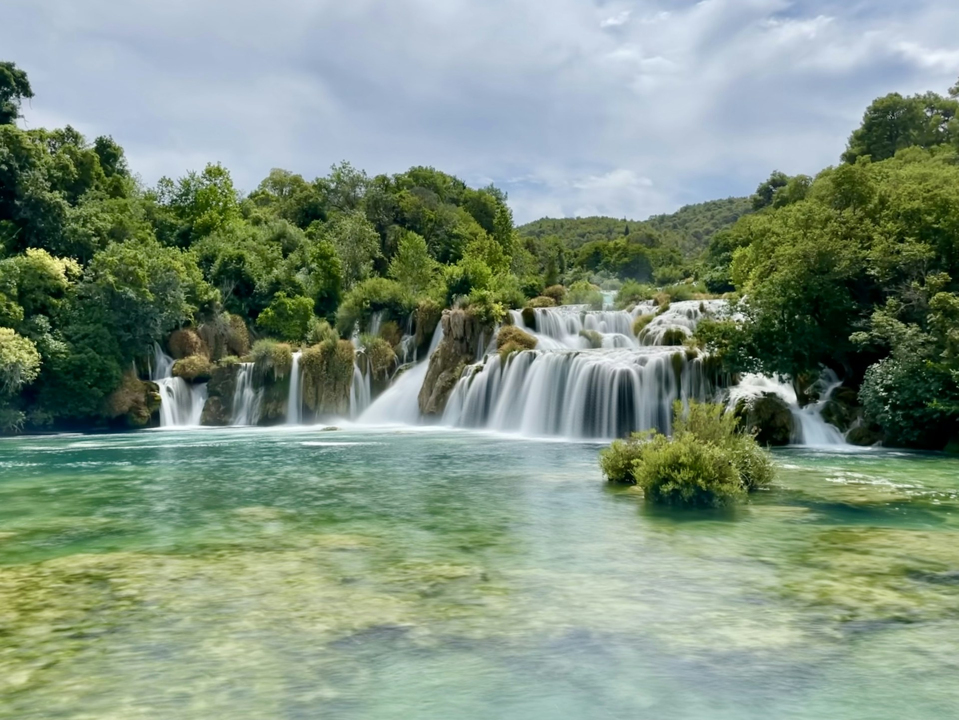 a large waterfall in the middle of a river