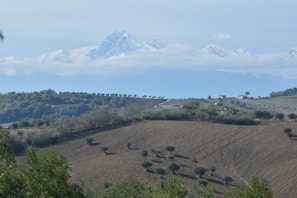 A serene Andean landscape with traditional houses and mountains in the background.