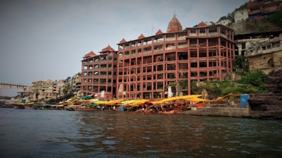 a large building sitting on the side of a river